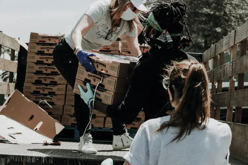 Voluntarios preparan cajas de donativos.